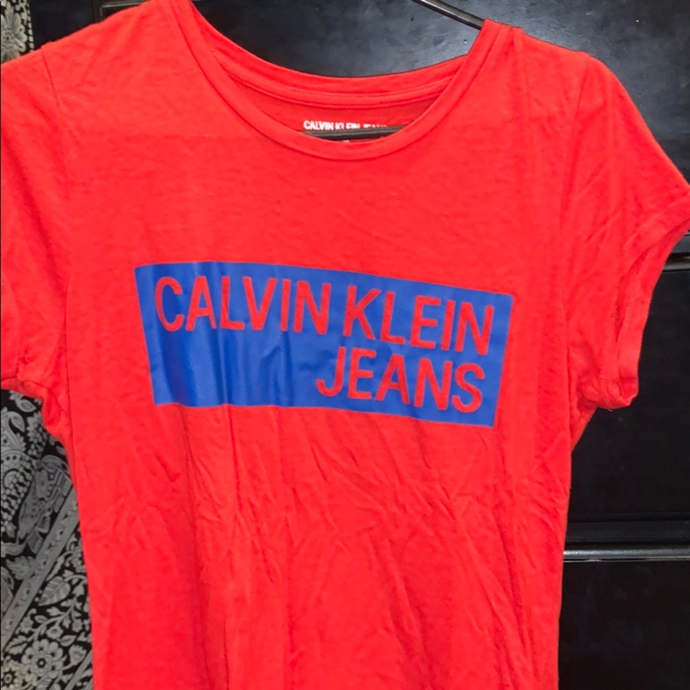 Red and blue Calvin Klein shorts sleeve shirt